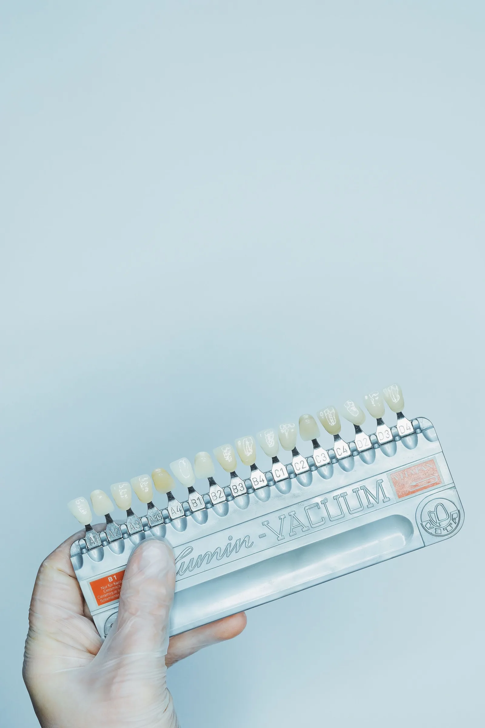 Hand holding a porcelain shade guide