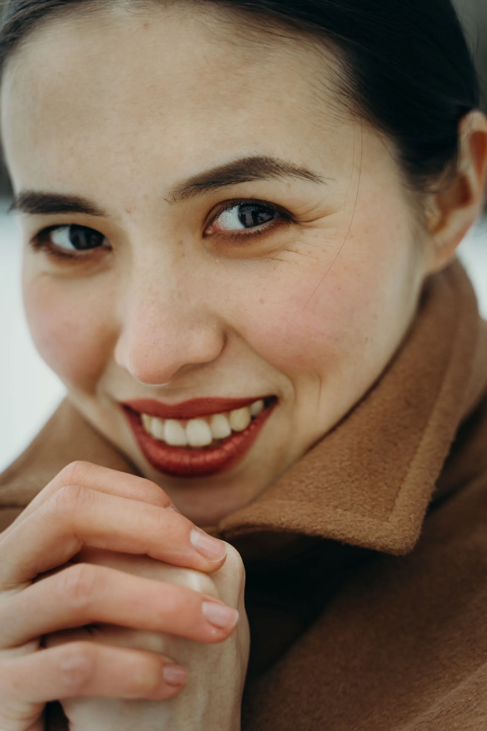 Smiling woman in a brown coat