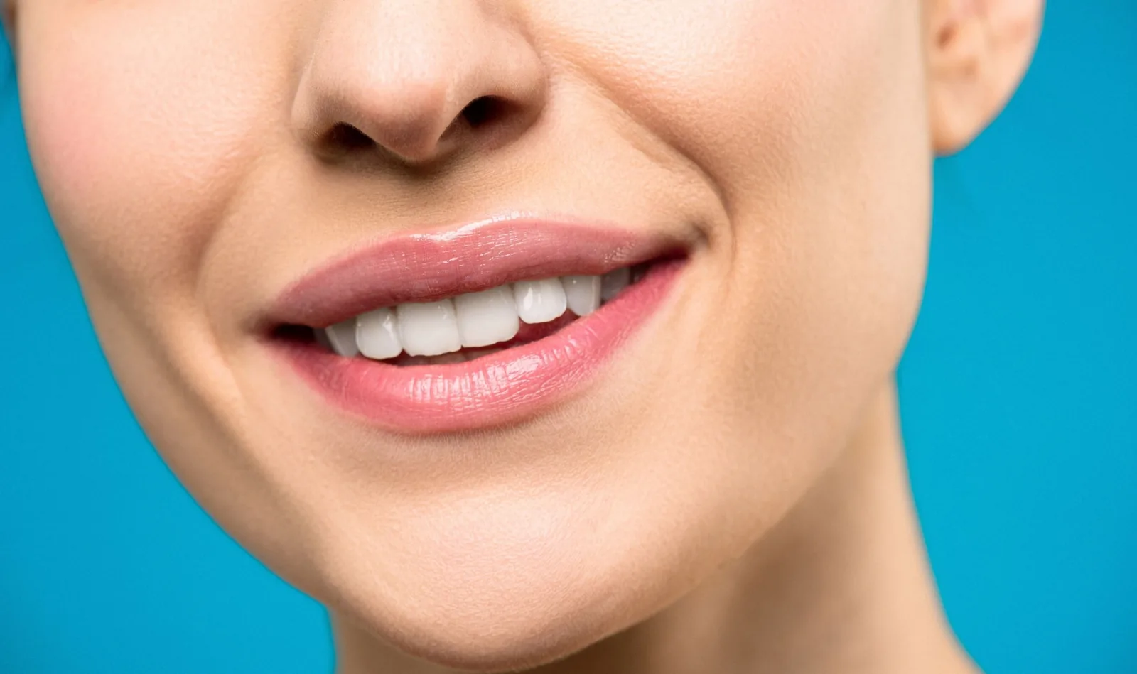 Close-up of a smile with pink lips, after