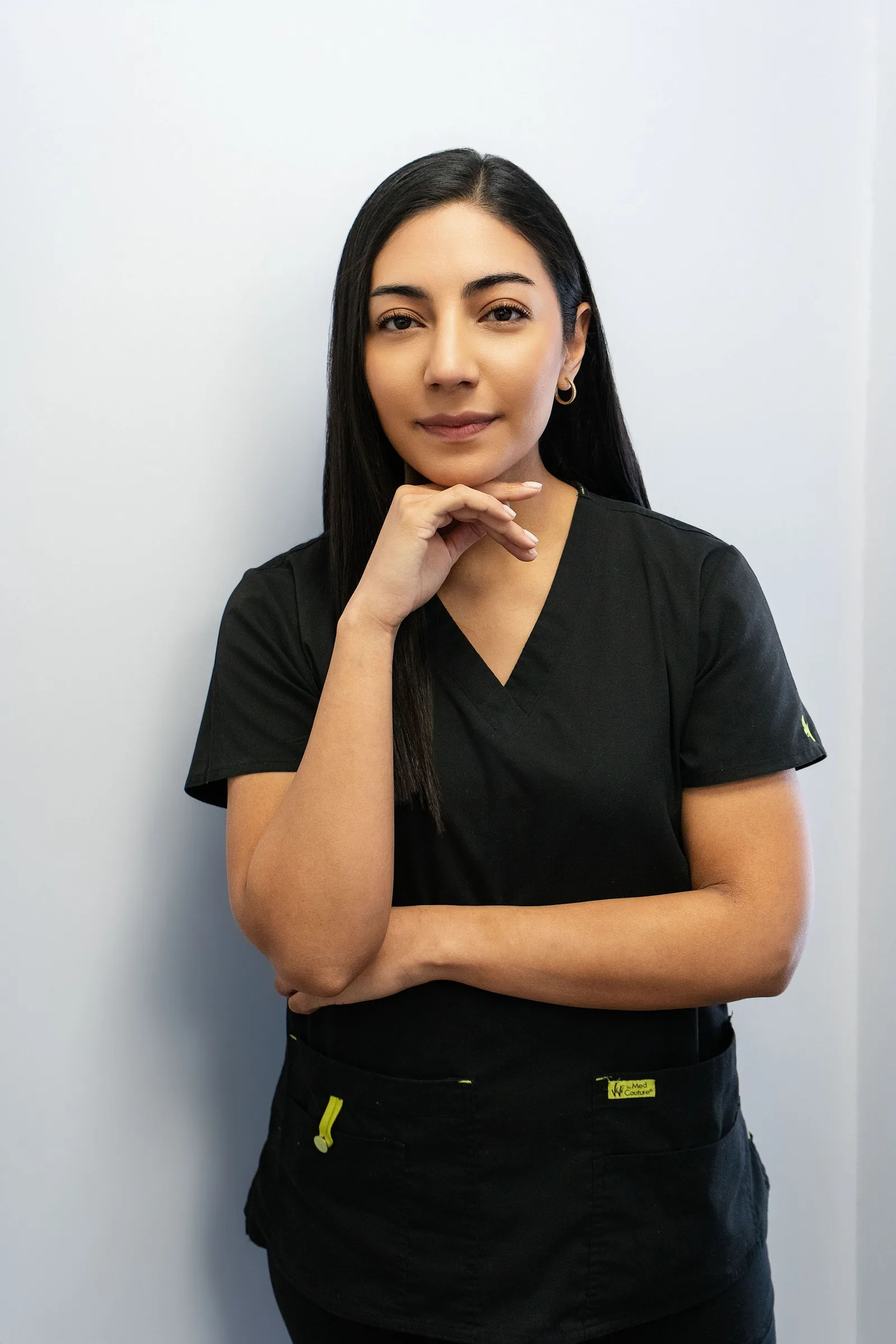 Portrait of a dentist in black scrubs